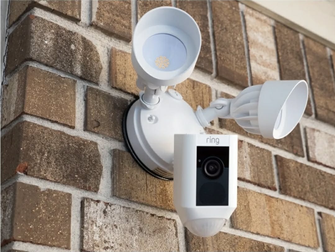 Security camera with floodlight installed on a wall