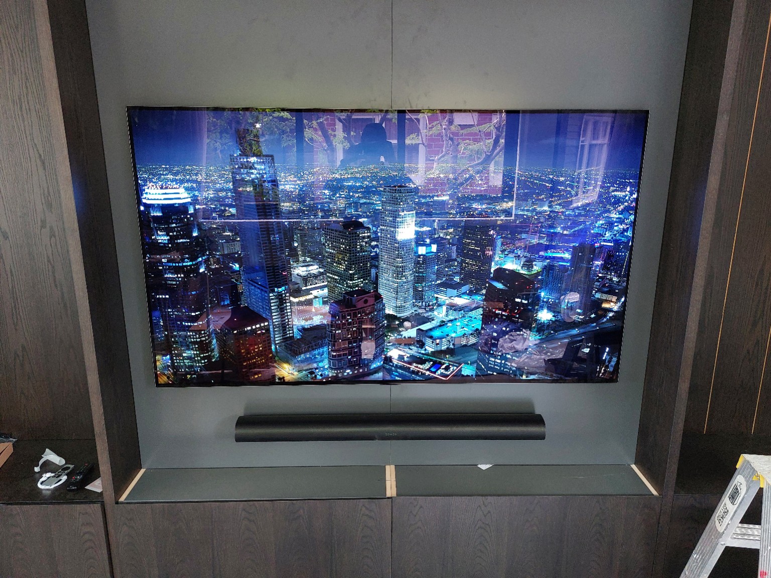 Wall-mounted TV with soundbar in a custom media cabinet