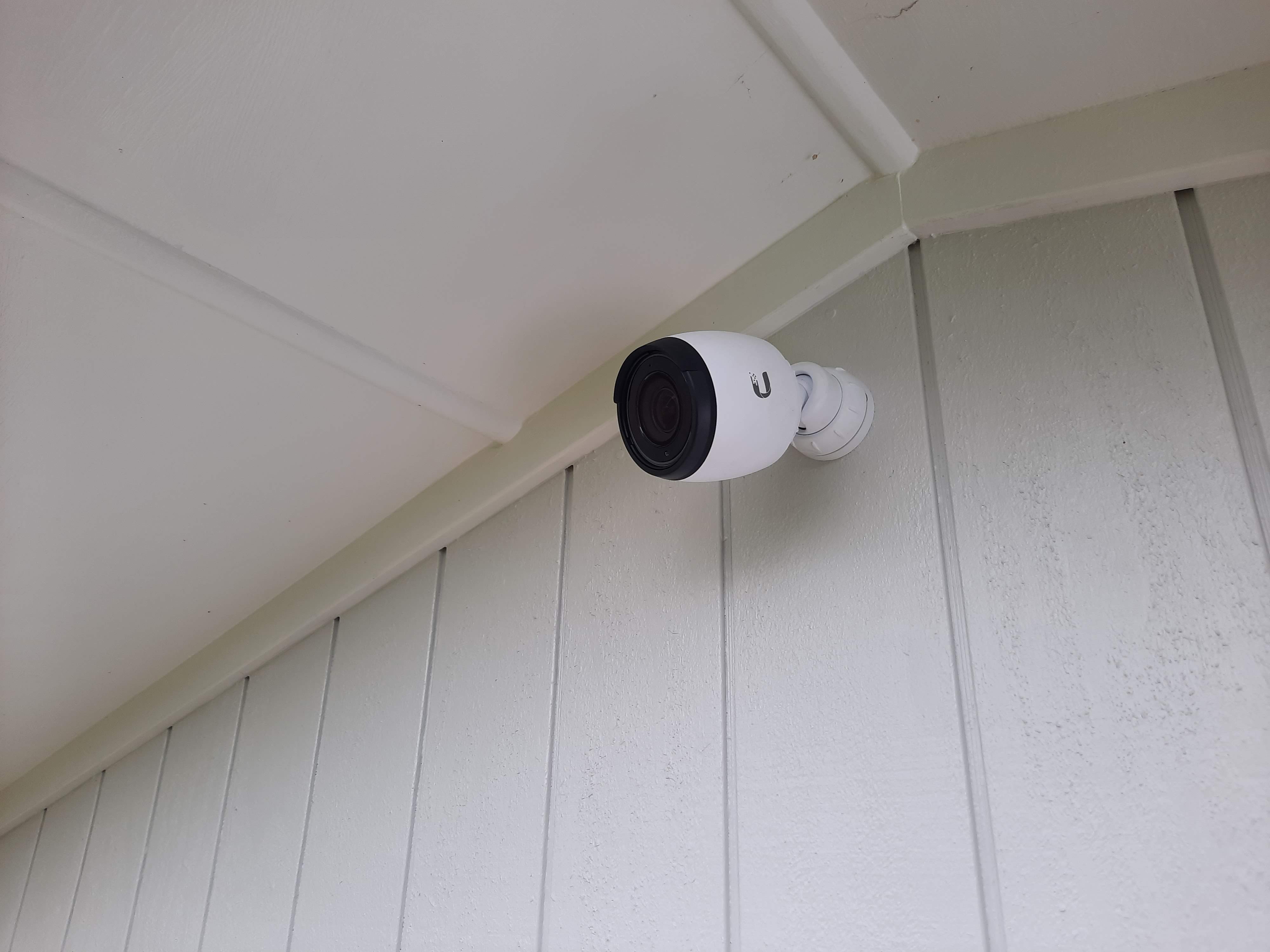 Security camera installed under the eaves of a house