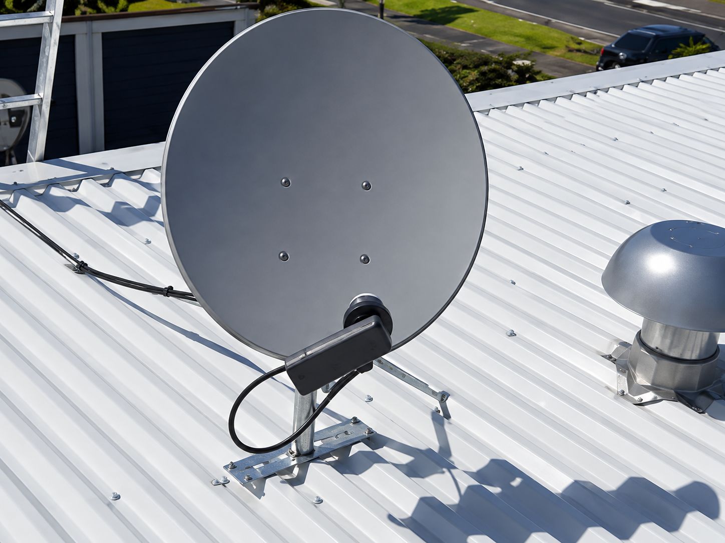 Satellite dish mounted on a metal roof